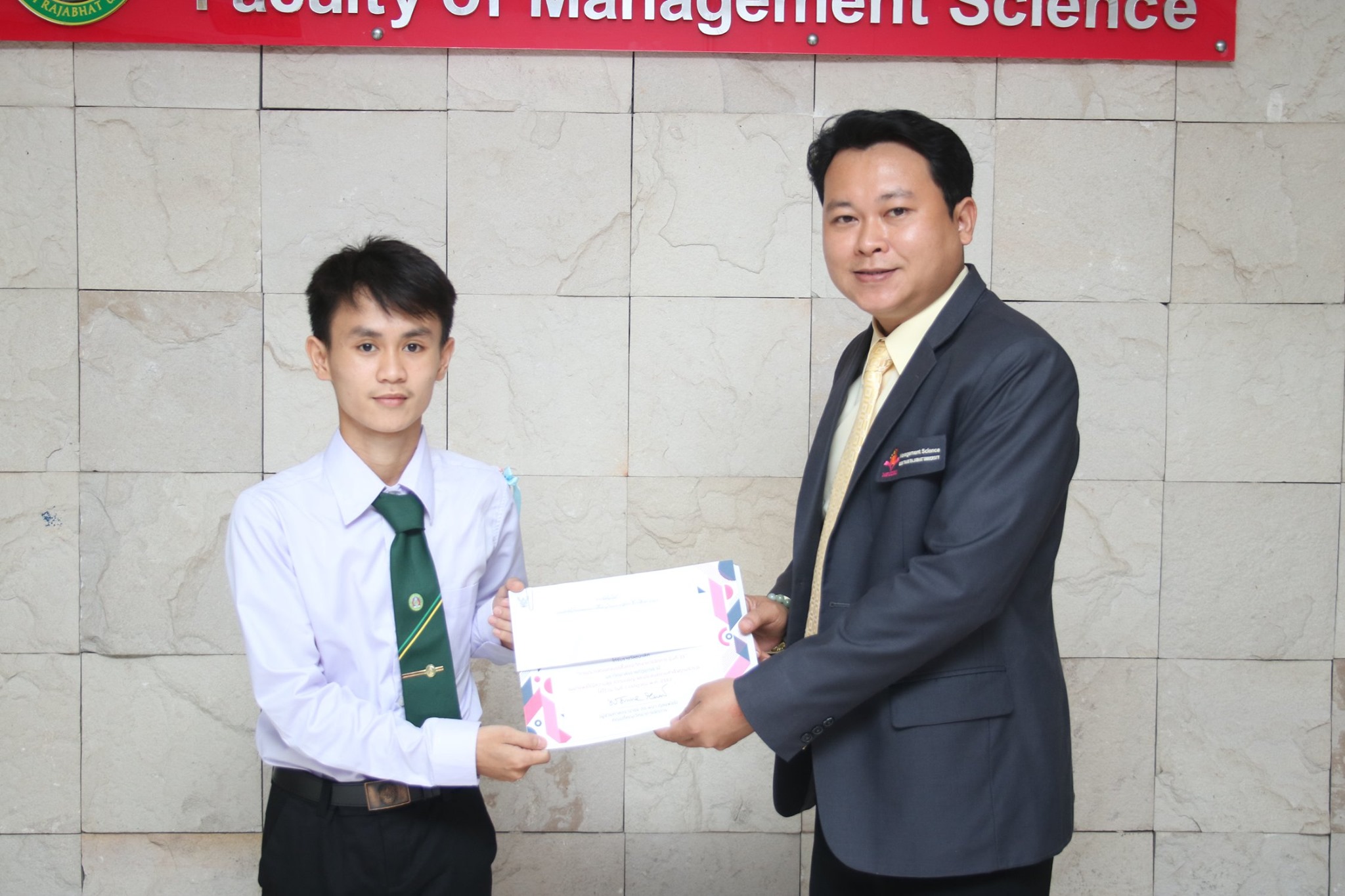 ผู้ช่วยศาสตราจารย์ ดร.พนา ดุลยพัชร์ คณบดีคณะวิทยาการจัดการ มอบเกียรติบัตรและเงินรางวัลการประกวดแข่งขันออกแบบเสื้อคณะวิทยาการจัดการ ปีการศึกษา 2563